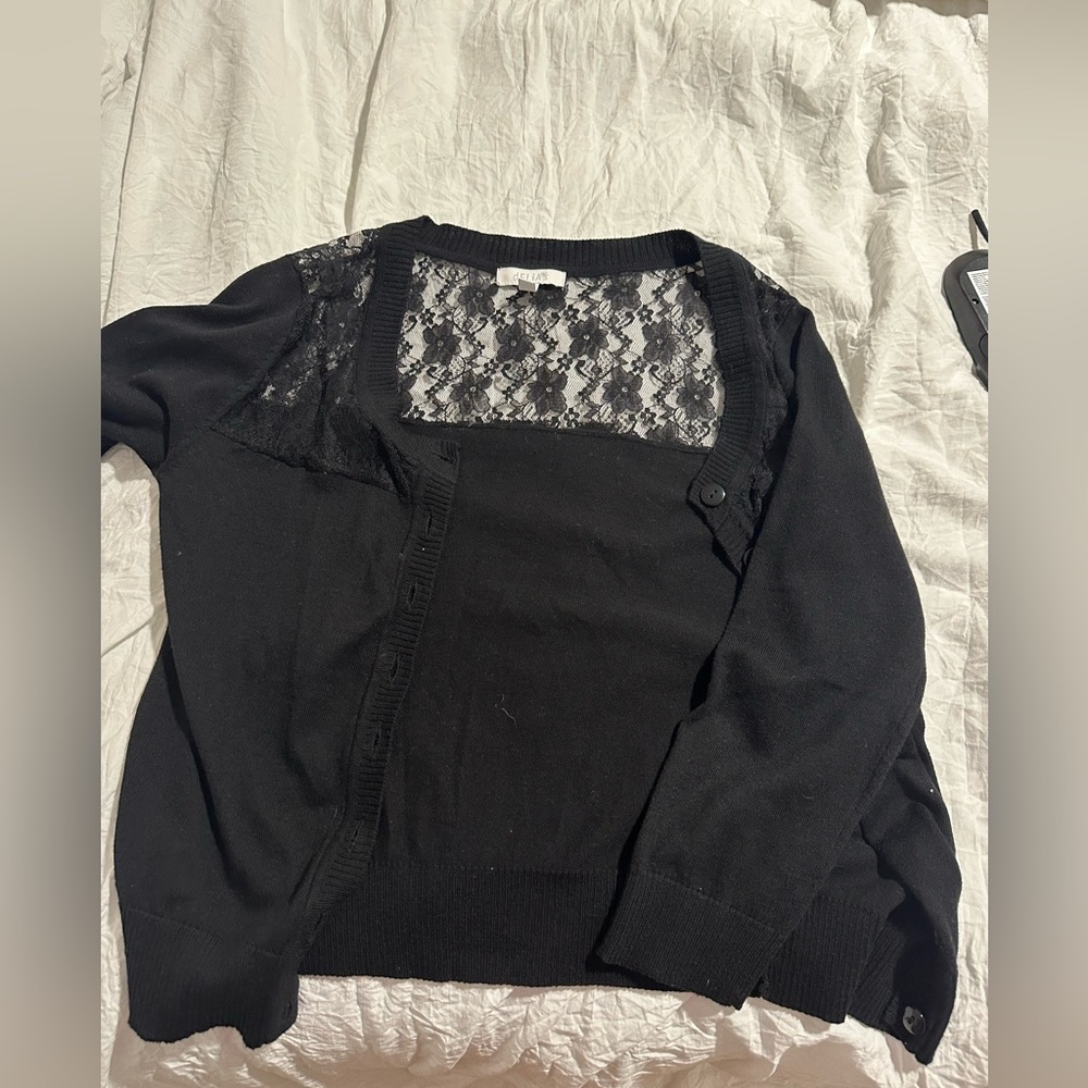 Delia’s black sweater jacket. Lace on back.